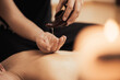 © alipko - Spa woman. Female enjoying relaxing back massage in cosmetology spa centre. Body care, skin care, wellness, wellbeing, beauty treatment concept.