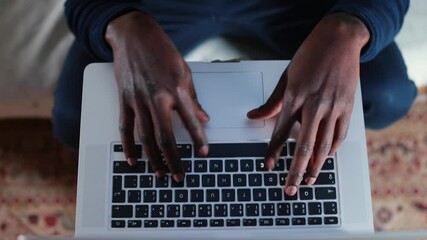 Poster - Black male freelancer typing text on laptop keyboard, preparing email to manager. Focus of attention in the monitor. Camera movement.