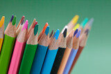 Fototapeta Las - color pencils on the green background
