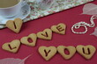 I love you made with cookies, Valentine,s breakfast with coffee, red and flowers background, pearls, słodki walentynkowy napis z ciasteczek