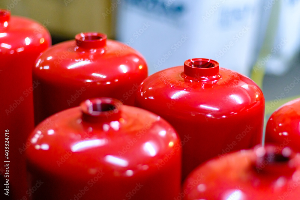 Top view of red empty fire extinguisher tanks in order waiting to be ...