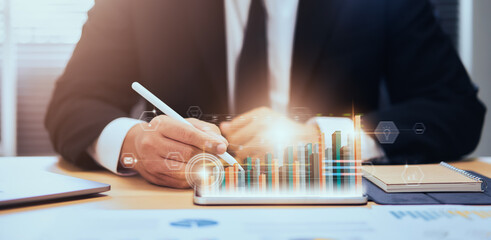 Stock exchange market concept, businessman hand trader press digital tablet with graphs analysis candle line on table in office, diagrams on screen.