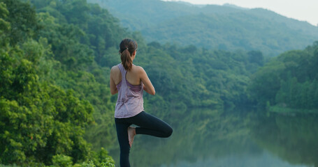 Wall Mural - Woman do yoga at country park