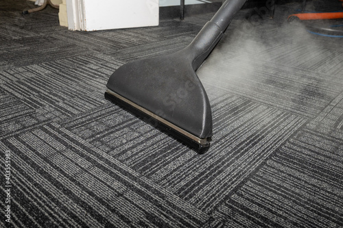 Steam carpet cleaning. Professional Carpet war, water extraction