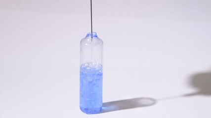 Wall Mural - the scientist injects chemicals into test tubes. test tube with colored liquid on the laboratory tab