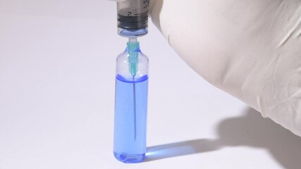 Wall Mural - the scientist injects chemicals into test tubes. test tube with colored liquid on the laboratory tab