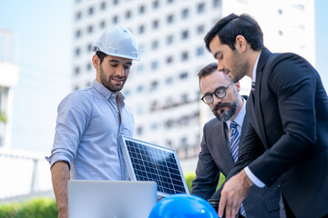 Wall Mural - Two businessmen discuss about renewable energy solar panels on site new project power solution business in front of office building.