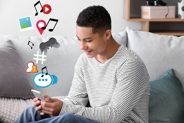 Canvas Print - African-American teenage boy using mobile phone for social networking at home