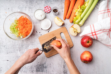 Making celery salad, step by step instruction. Step 4 - grating apples