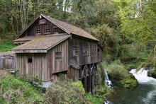 An Eye Level View Of Cedar Creek Grist Mill From The Bridge Looking Towards The Mill And River
