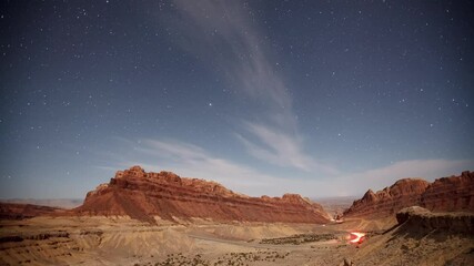 Wall Mural - Time lapse of a road going the desert with the night sky moving above.