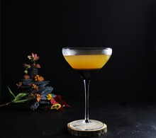 Whiskey Cocktail In A Coupe Glass Against A Black Background