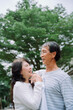 © THESHOTS.CO - Old couple embracing at park with happiness.