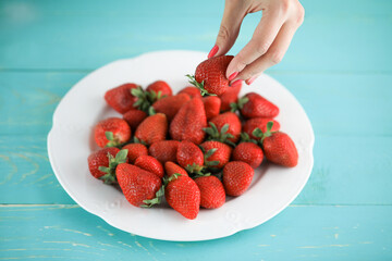 Juicy tasty ripe strawberry on a plate.