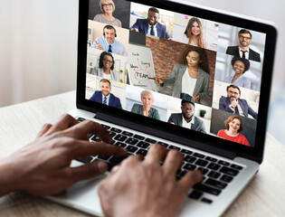 Wall Mural - Black businessman having online business training via laptop in office