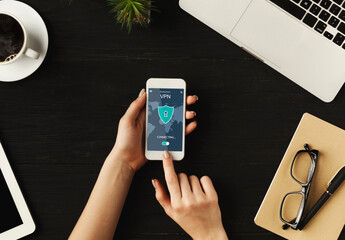 Poster - Woman holding and using smartphone with vpn app