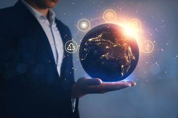 night earth in the hands of man with icons energy sources for renewable. eco development. energy sav
