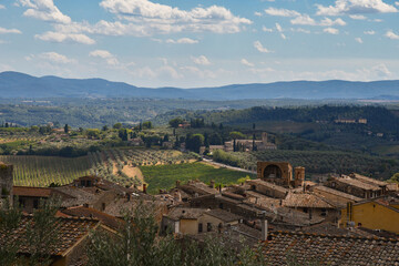 Poster - Rooftop view of the medieval town of San Gimignano, Unesco World Heritage Site, with the Tuscan hills in the background, Siena, Tuscany, Italy