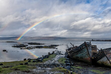 Rainbow And Beached Old Wooden Fishing Boats On Shore At Salen
