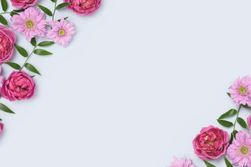 Wall Mural - frame made of aster, rose flowers and green leaves texture on a blue pastel background. springtime c