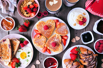 Aufkleber - Valentines or Mothers Day brunch table scene. Top view on a dark wood background. Heart shaped pancakes, eggs and an assortment of love themed food.