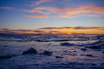 Poster - Sunset over the ocean and cracked ice field, on a winter day in Iceland.