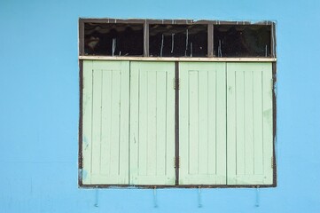 wooden windoe on blue wall