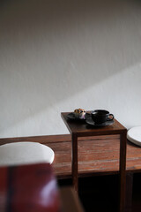 Wall Mural - Coffee cup with muffin on wood table in local coffee shop