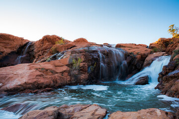 Wall Mural - Waterfalls flowing over red sandstone, Gunlock Falls, UT