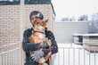 © Елена Григорович - After Snow battle. Adult man hugging his dog Shiba inu during a snowfall at winter day