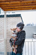 © Елена Григорович - After Snow battle. Adult man hugging his dog Shiba inu during a snowfall at winter day