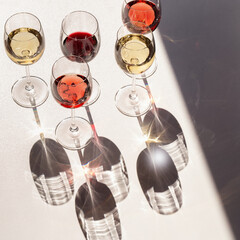 Wall Mural - Set of wine in glasses. Red, rose and white wine. Hard light.