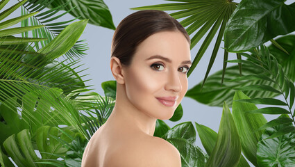 Wall Mural - Beautiful young woman and tropical leaves, banner design. Spa portrait