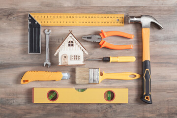 Wall Mural - Work tools with a wooden house model.