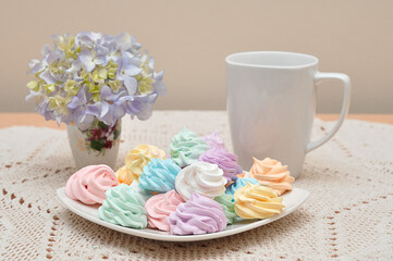 Wall Mural - A tea setting with a mug and plate of meringues