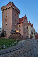 Poster - red brick tower reconstructed royal castle  in the evening