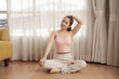 © THESHOTS.CO - Healthy asian beauty woman doing yoga on wooden mat at home.