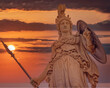 © Dimitrios - Athena statue the ancient Greek goddess of wisdom and knowledge illuminated by dramatic sun burned sky, Athens Greece