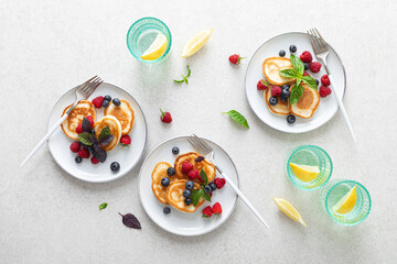 Canvas Print - Pancakes with fresh blueberry and raspberry served for healthy vegetarian breakfast