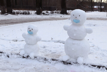 snowmans in a mask on the street 