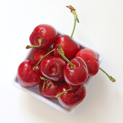 Portion of cherries on white background