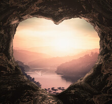 Heart Shape Of Cave On River And Mountains Sunset Background