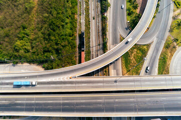 Wall Mural - Aerial view of cargo Truck and train container on highway road with car, transportation concept.,import,export logistic industrial Transporting Land transport on the asphalt expressway