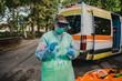 © loreanto - Young doctor with protective suit and face mask prepares swab for a patient on the street next to the ambulance - Millennial paramedic at work during the global Covid-19 pandemic, Coronavirus