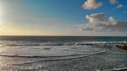 Poster - Overhead aerial view of beautiful waves along the beach at sunset