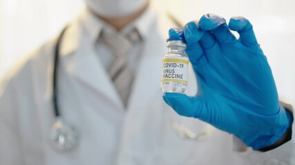Wall Mural - doctor hand in blue gloves holding covid-19 vaccine and syringe disease preparing for coronavirus in