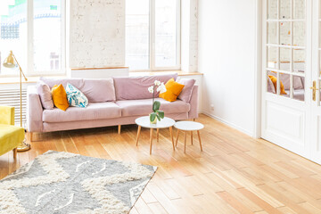 Scandinavian style apartment interior. bright yellow warm colors. wooden flooring. sunlight in large windows.