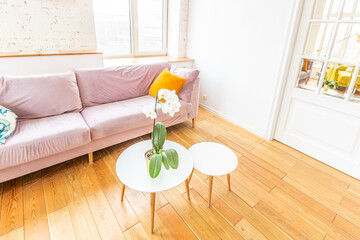 Scandinavian style apartment interior. bright yellow warm colors. wooden flooring. sunlight in large windows.