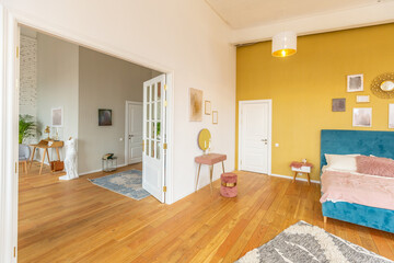 Scandinavian style apartment interior. bright yellow warm colors. wooden flooring. sunlight in large windows.