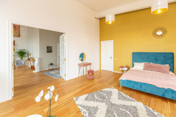 Scandinavian style apartment interior. bright yellow warm colors. wooden flooring. sunlight in large windows.